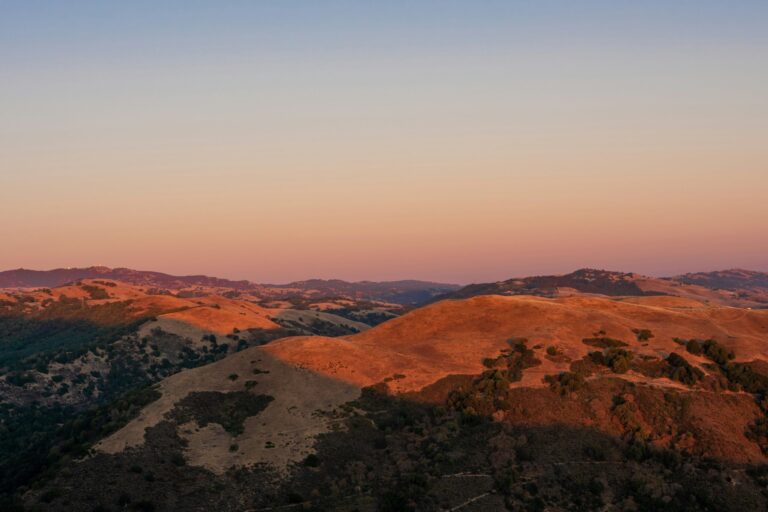 brown and green mountains under blue sky